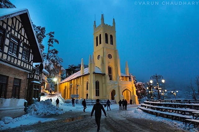 A snowy ski lift surrounded by winter scenery.