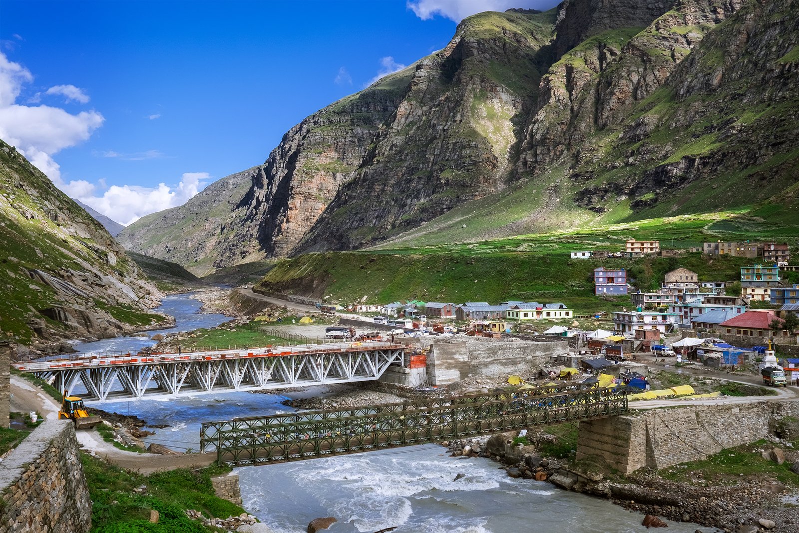 A festive night scene at a Christmas market, bustling with a lively crowd of people enjoying the holiday spirit.